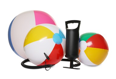 Photo of Inflatable balls and manual air pump isolated on white