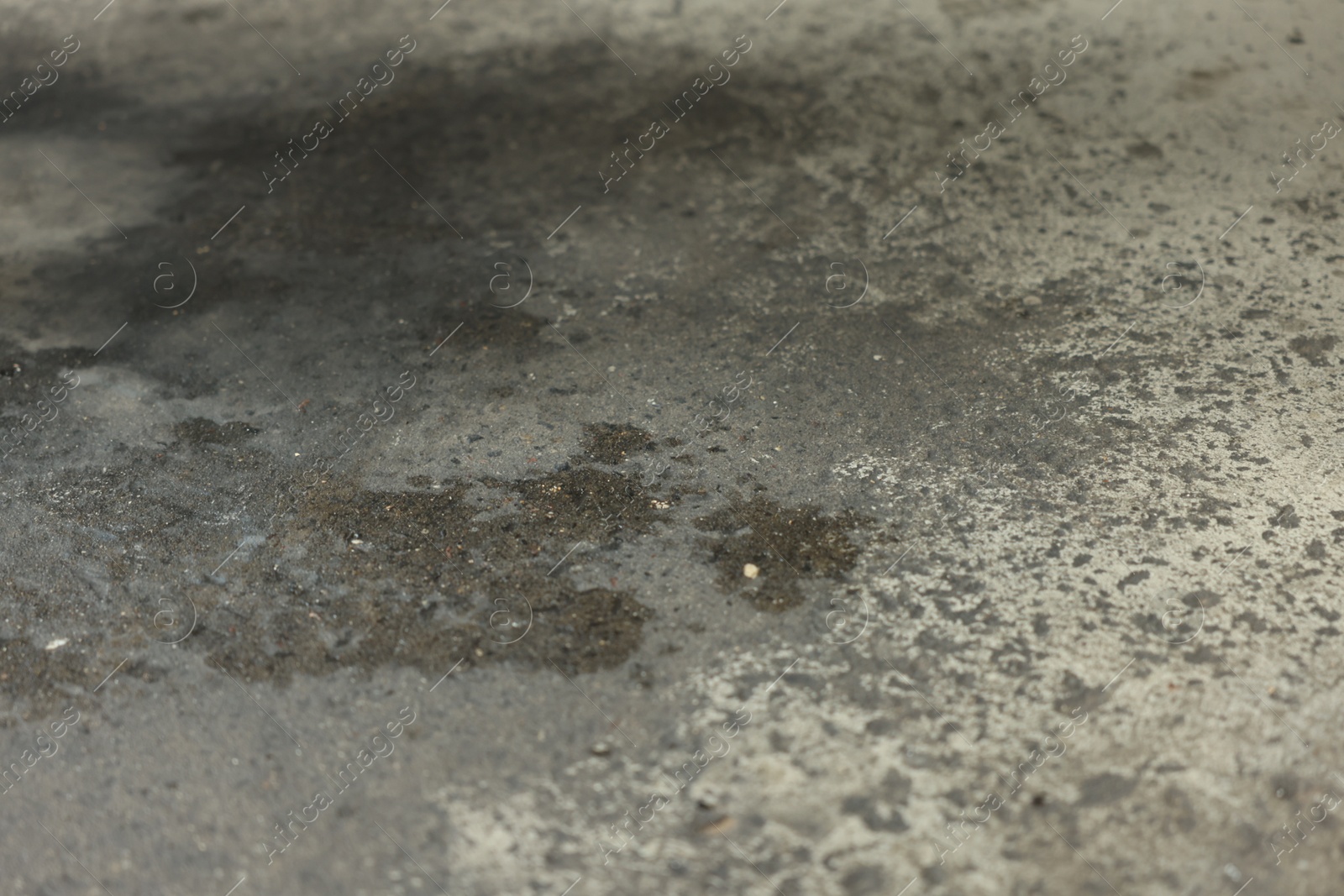 Stains of motor oil on asphalt outdoors, closeup Photo of Stains of motor oil on asphalt outdoors, closeup