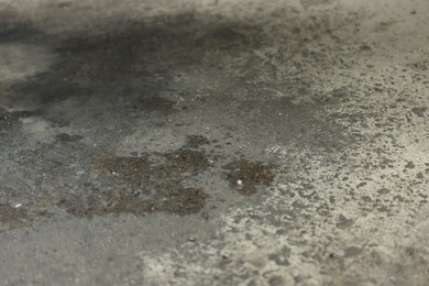 Photo of Stains of motor oil on asphalt outdoors, closeup