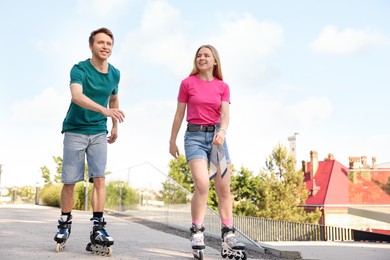 Photo of Happy couple roller skating together on street