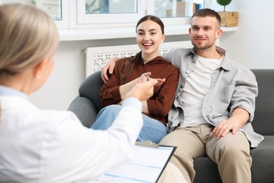 Photo of In vitro fertilization (IVF). Couple having consultation with doctor in reproductive clinic