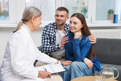 Photo of In vitro fertilization (IVF). Doctor encouraging young couple in reproductive clinic