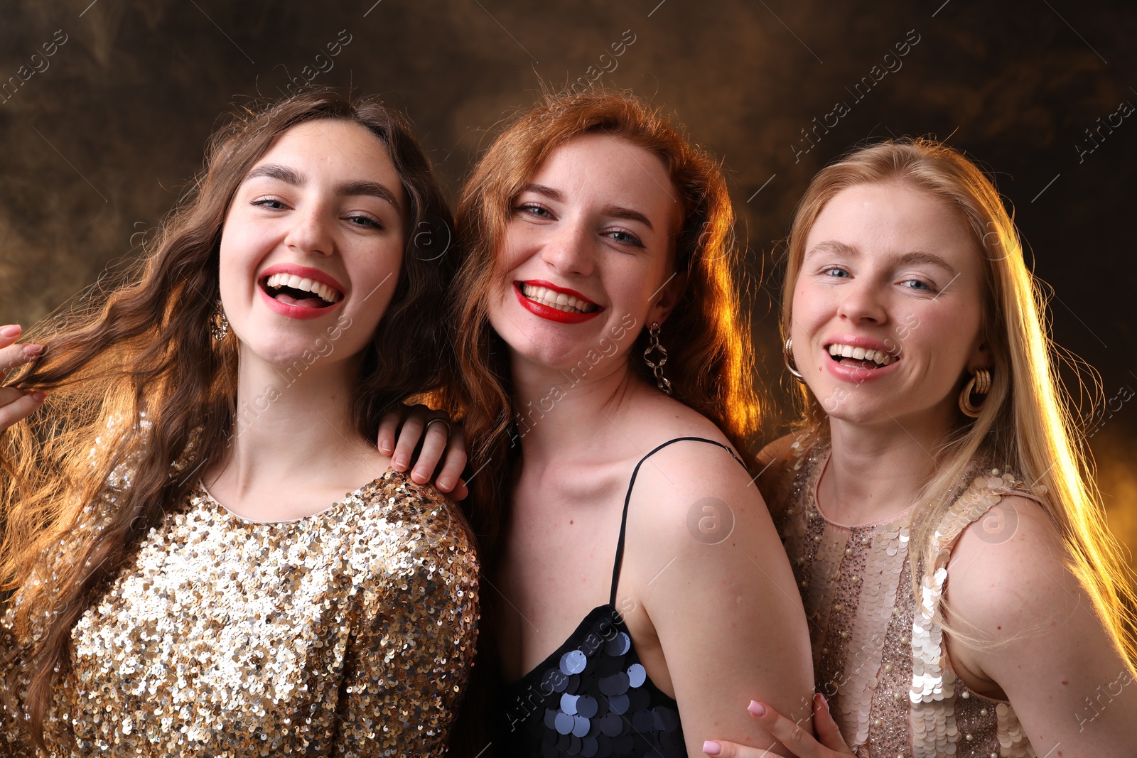 Beautiful women with different hair colors on dark background with smoke Photo of Beautiful women with different hair colors on dark background with smoke