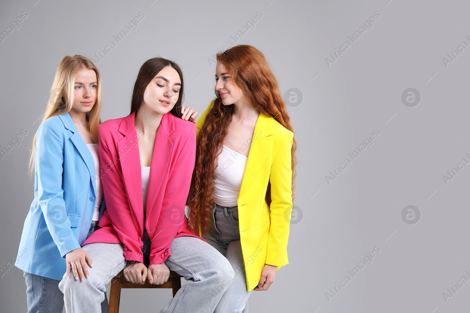Photo of Beautiful women with different hair colors on light grey background, space for text