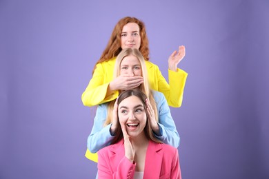Photo of Beautiful women with different hair colors having fun on purple background