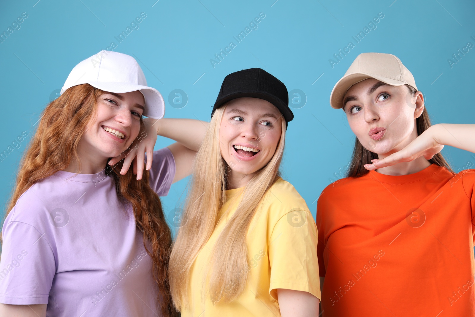 Beautiful women with different hair colors on light blue background Photo of Beautiful women with different hair colors on light blue background