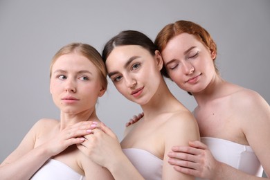 Photo of Beautiful women with different hair colors on grey background