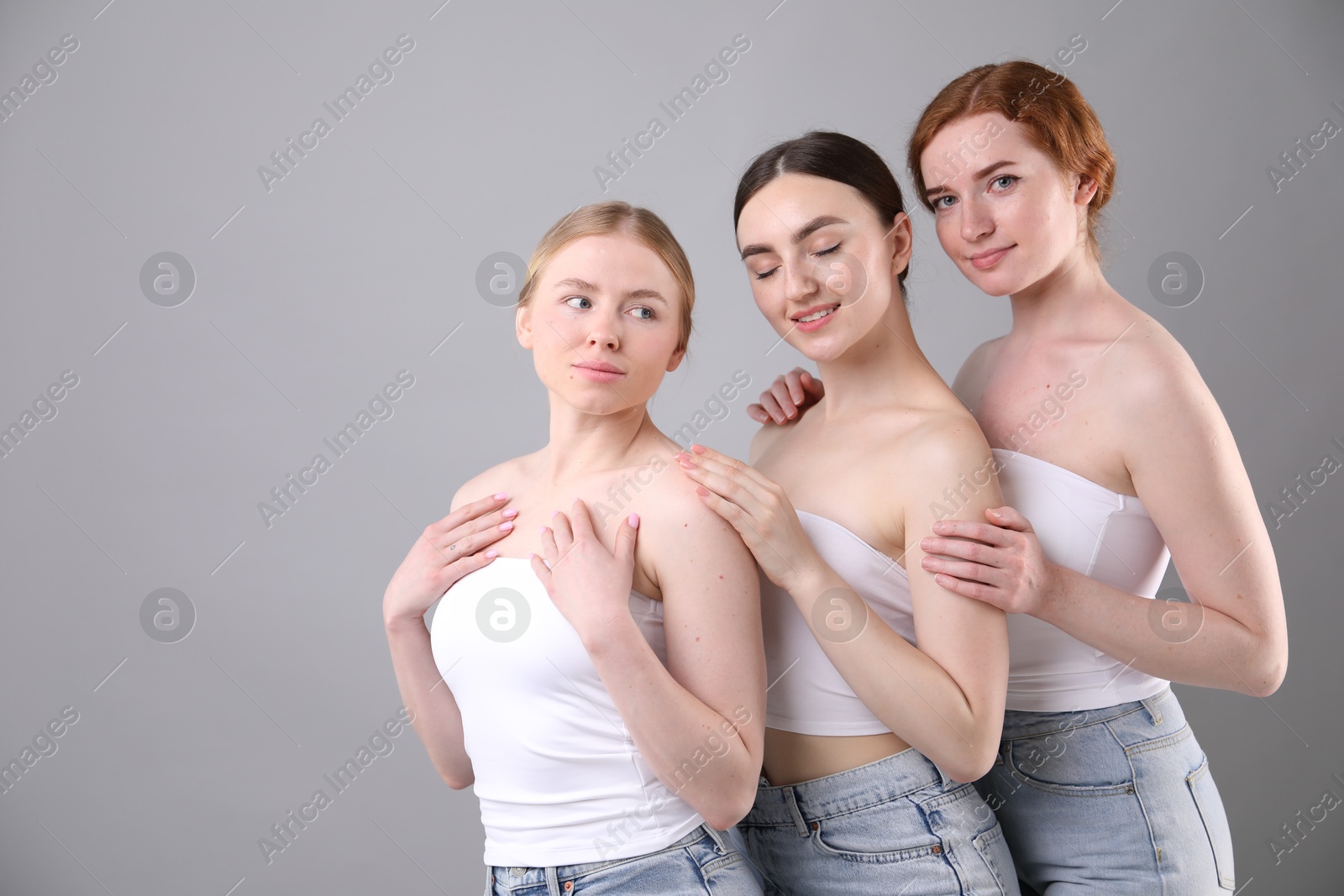 Beautiful women with different hair colors on grey background, space for text Photo of Beautiful women with different hair colors on grey background, space for text