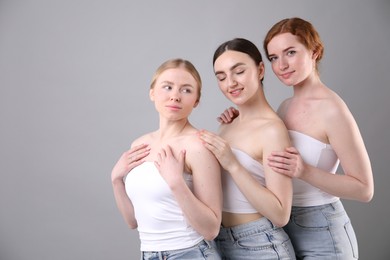 Photo of Beautiful women with different hair colors on grey background, space for text