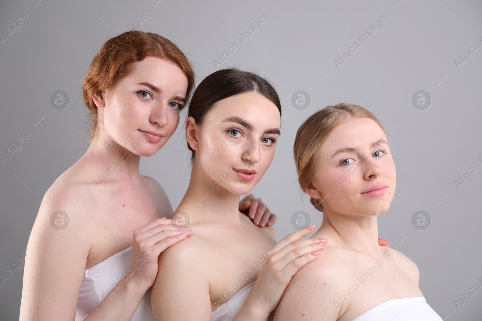 Photo of Beautiful women with different hair colors on grey background