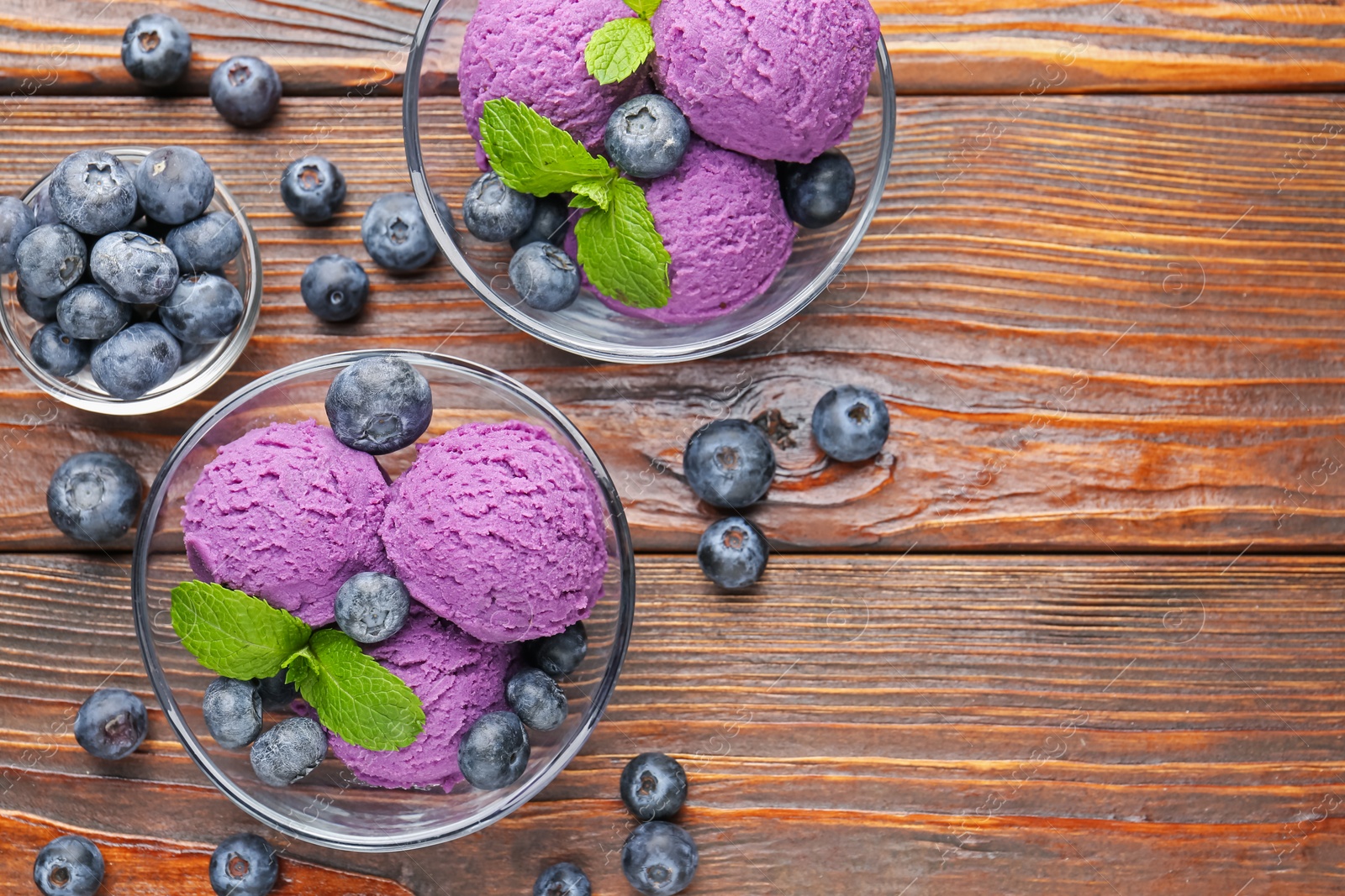 Tasty sorbet with blueberries and mint served on wooden table, flat lay. Space for text Photo of Tasty sorbet with blueberries and mint served on wooden table, flat lay. Space for text