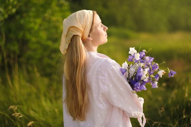 Photo of Beautiful woman with bouquet of wildflowers in meadow on sunny day
