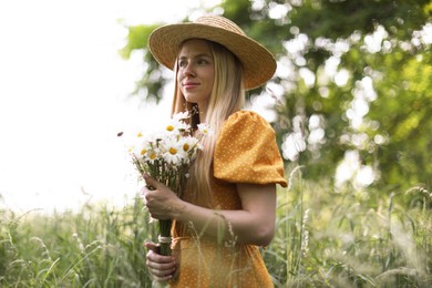 Photo of Beautiful woman with bouquet of wildflowers in forest