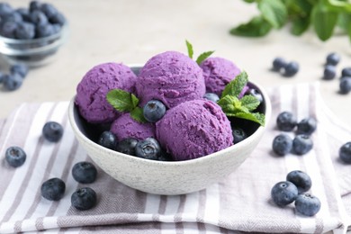 Photo of Tasty sorbet with blueberries and mint on light grey table, closeup