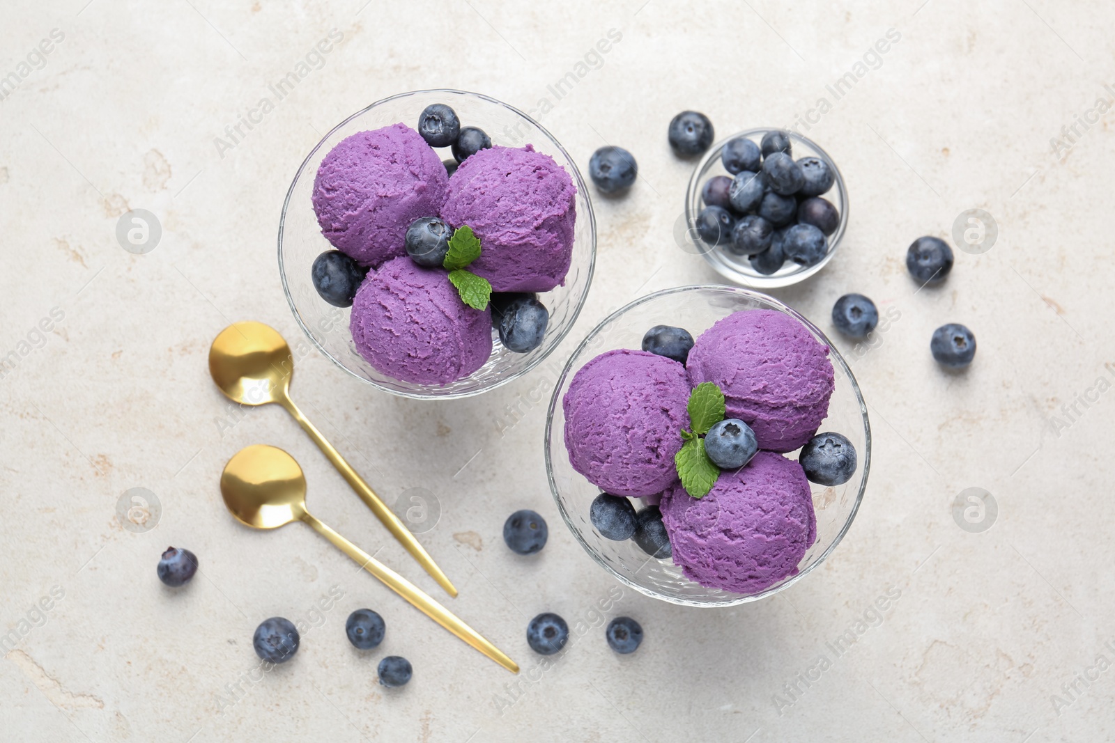 Photo of Tasty sorbet with blueberries and mint on light grey table, flat lay