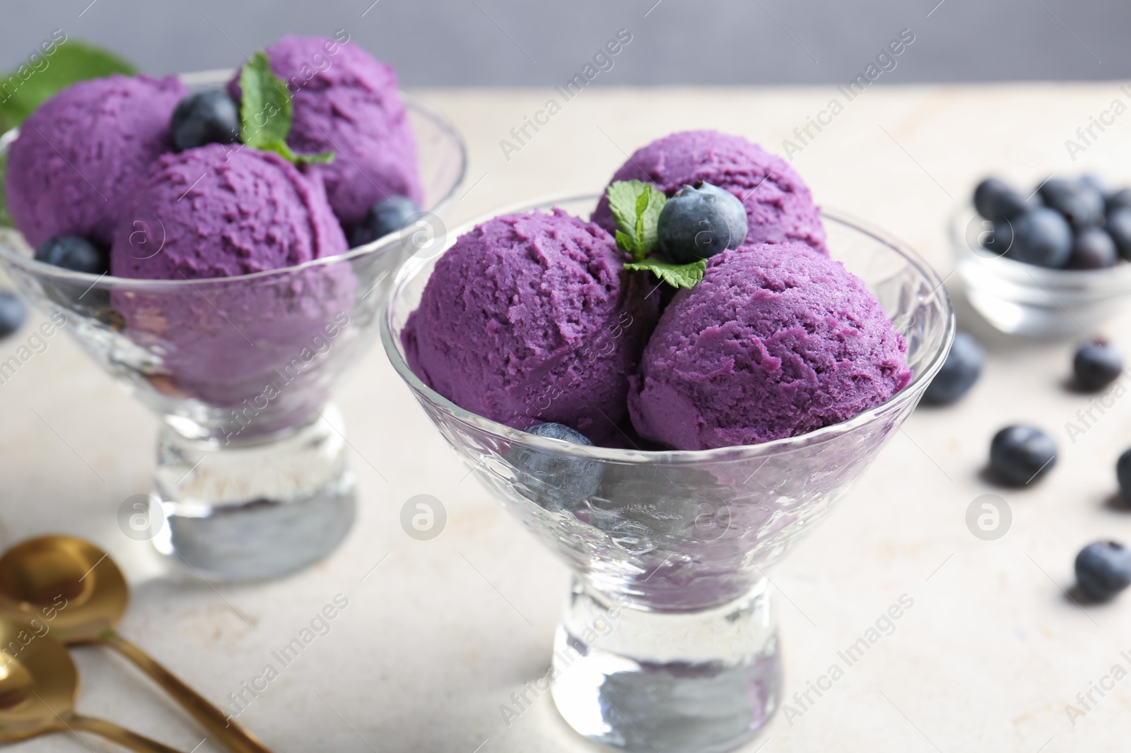 Tasty sorbet with blueberries and mint on light grey table, closeup Photo of Tasty sorbet with blueberries and mint on light grey table, closeup