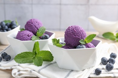 Photo of Tasty sorbet with blueberries and mint on table, closeup