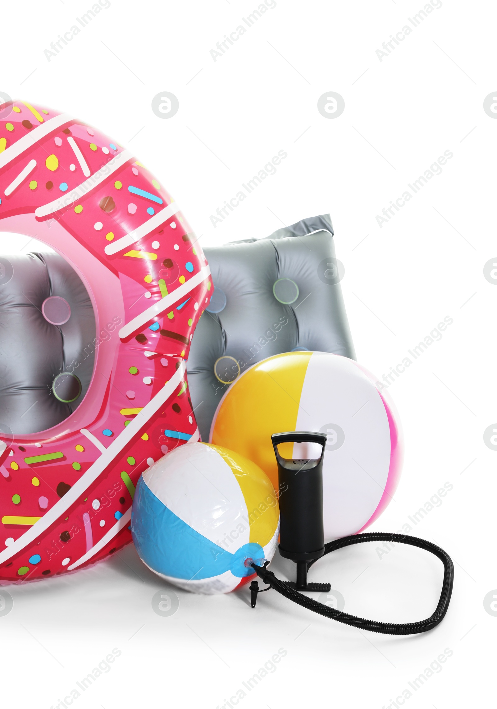 Inflatable ring, mattress, balls and manual air pump isolated on white Photo of Inflatable ring, mattress, balls and manual air pump isolated on white