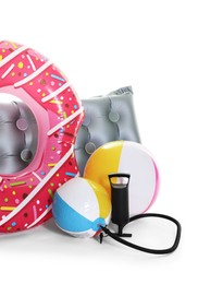 Photo of Inflatable ring, mattress, balls and manual air pump isolated on white