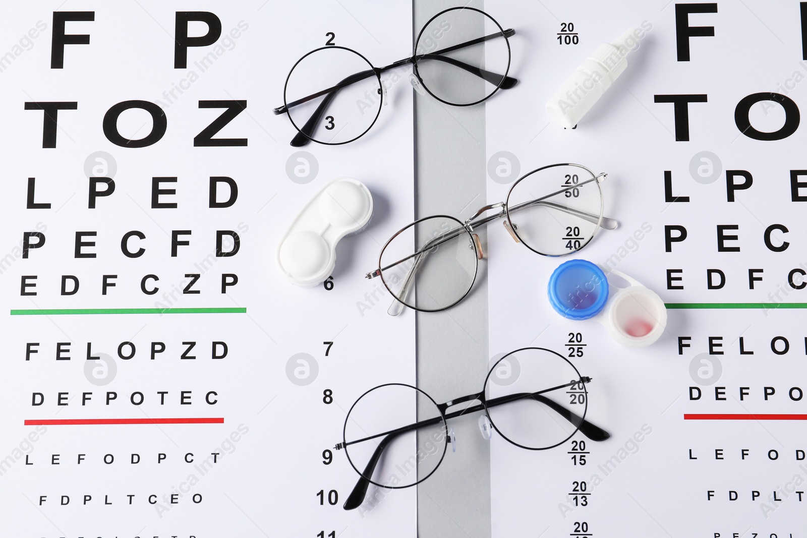 Vision test charts, glasses, lenses and bottle of medical drops on light grey background, flat lay Photo of Vision test charts, glasses, lenses and bottle of medical drops on light grey background, flat lay