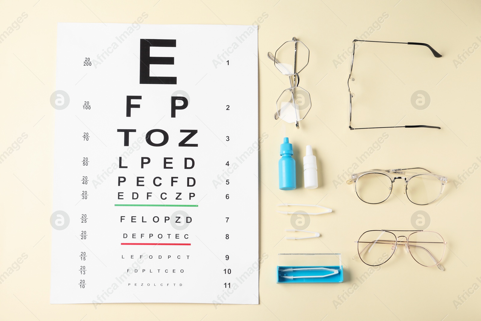 Vision test chart, glasses, tweezers and bottles of medical drops on beige background, flat lay Photo of Vision test chart, glasses, tweezers and bottles of medical drops on beige background, flat lay