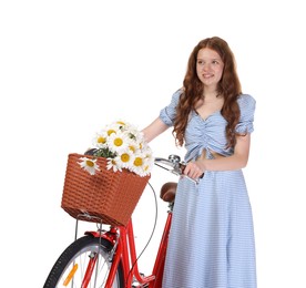 Photo of Smiling teenage girl in dress and bicycle with basket of flowers against white background