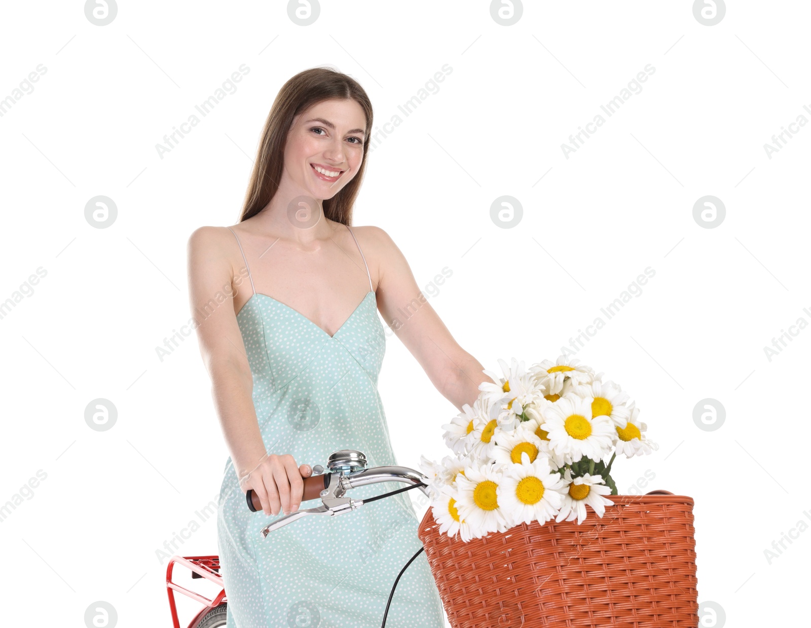 Photo of Smiling woman in dress posing on bicycle with basket of flowers against white background