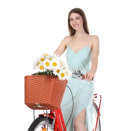 Photo of Smiling woman in dress posing on bicycle with basket of flowers against white background