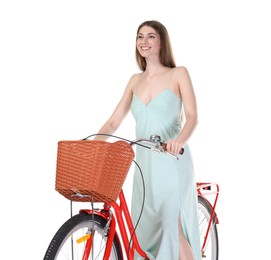 Photo of Smiling woman in dress posing on bicycle with basket against white background