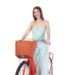 Photo of Smiling woman in dress posing on bicycle with basket against white background