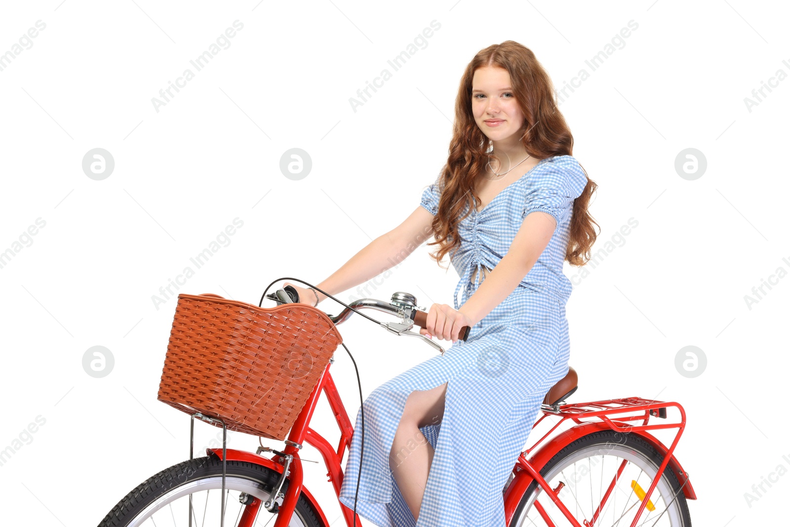 Photo of Beautiful teenage girl posing on bicycle with basket against white background