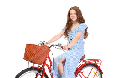 Photo of Beautiful teenage girl posing on bicycle with basket against white background
