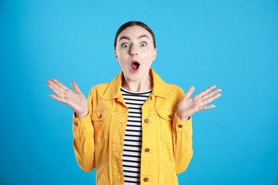 Photo of Portrait of surprised woman on light blue background