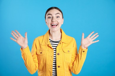 Photo of Portrait of surprised woman on light blue background