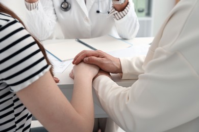 Photo of In vitro fertilization (IVF). Couple having consultation with doctor in reproductive clinic, closeup