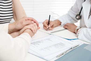 Photo of In vitro fertilization (IVF). Couple having consultation with doctor in reproductive clinic, closeup