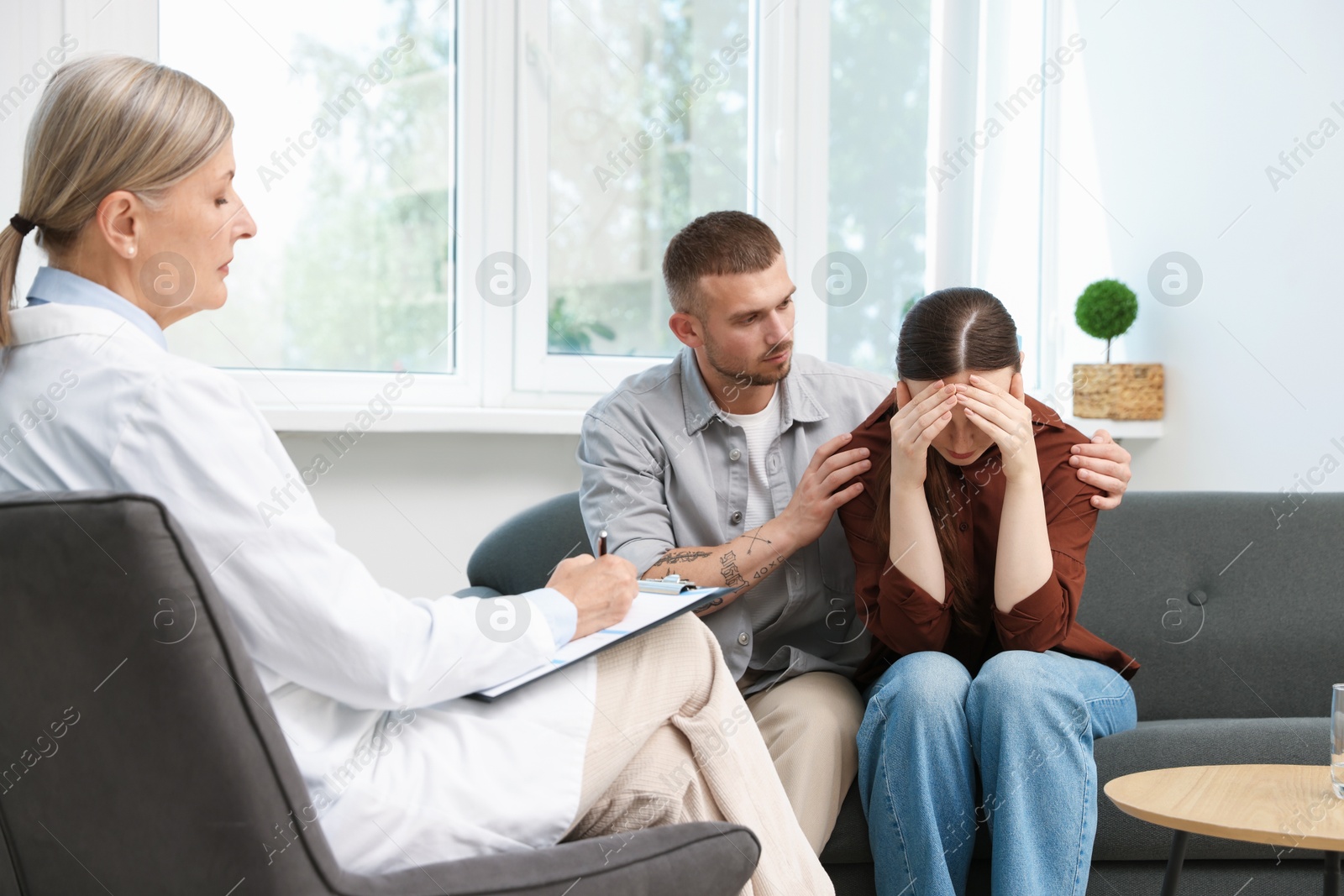 Photo of In vitro fertilization (IVF). Upset couple having consultation with doctor in reproductive clinic
