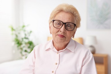 Photo of Portrait of senior woman in glasses at home