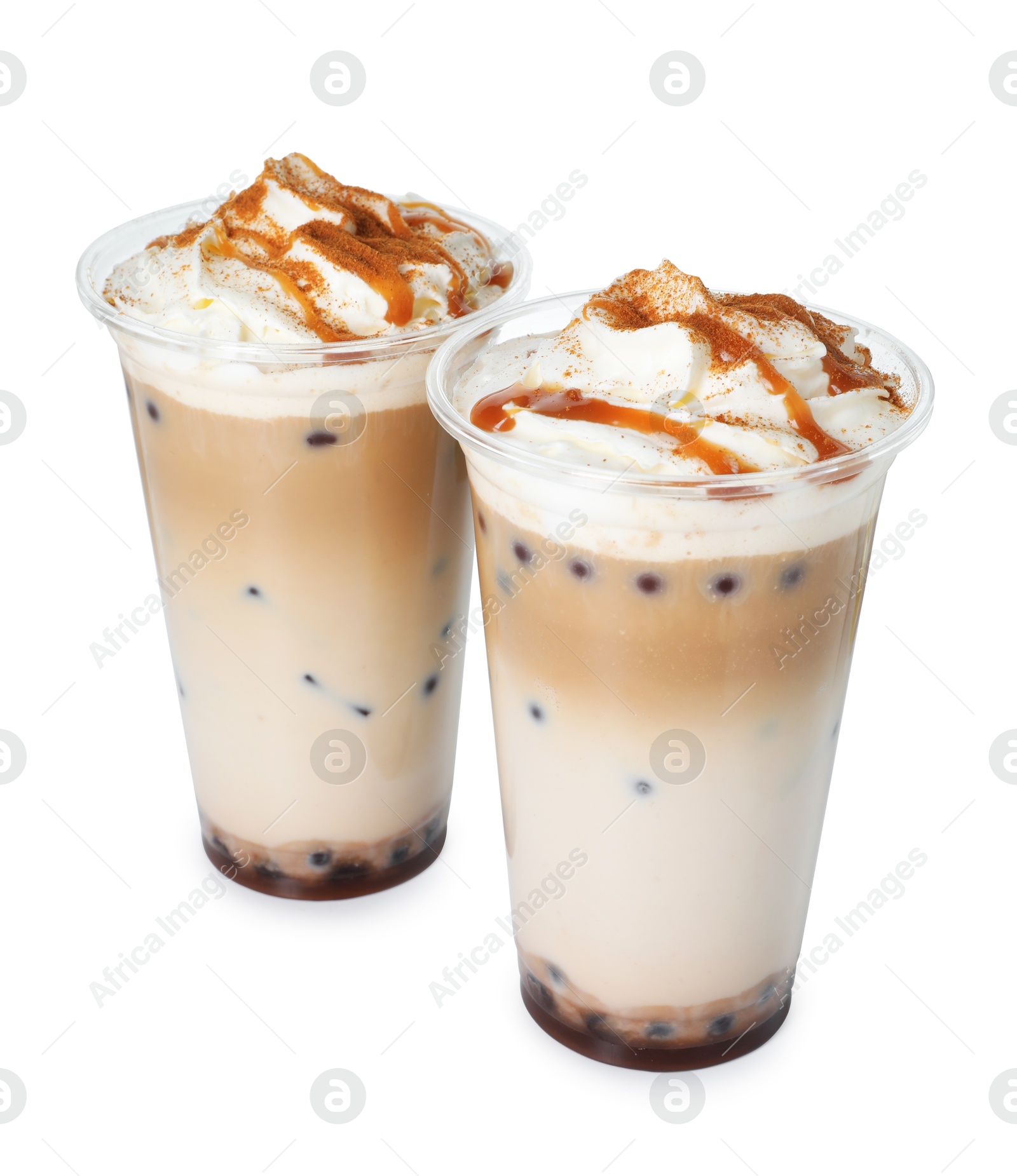 Tasty milk bubble tea in plastic cups isolated on white Photo of Tasty milk bubble tea in plastic cups isolated on white