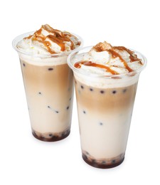 Photo of Tasty milk bubble tea in plastic cups isolated on white