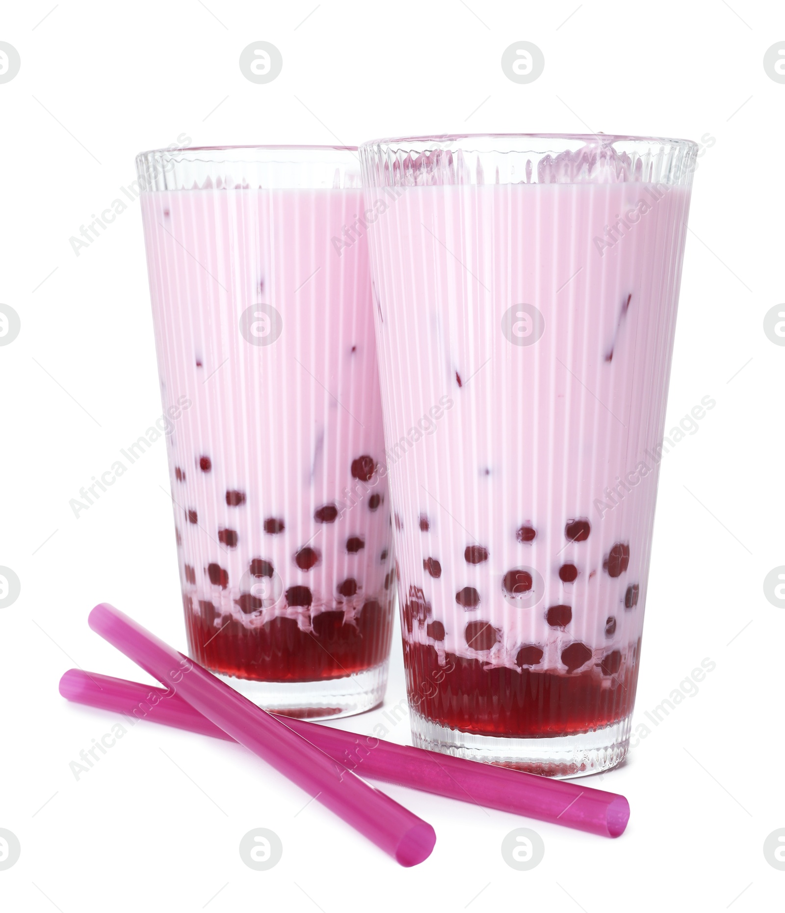 Tasty milk bubble tea in glasses isolated on white Photo of Tasty milk bubble tea in glasses isolated on white