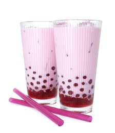 Photo of Tasty milk bubble tea in glasses isolated on white