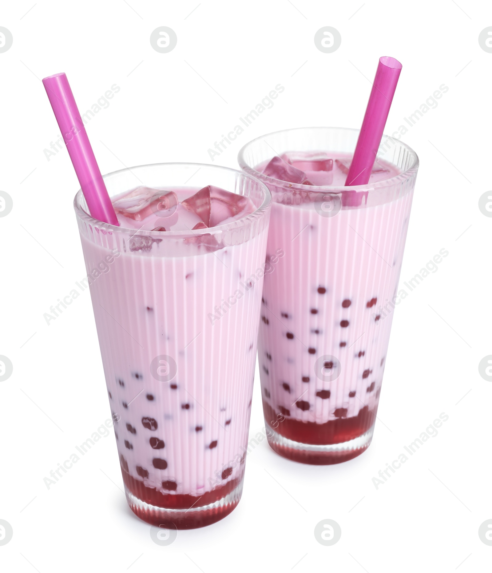 Tasty milk bubble tea in glasses isolated on white Photo of Tasty milk bubble tea in glasses isolated on white