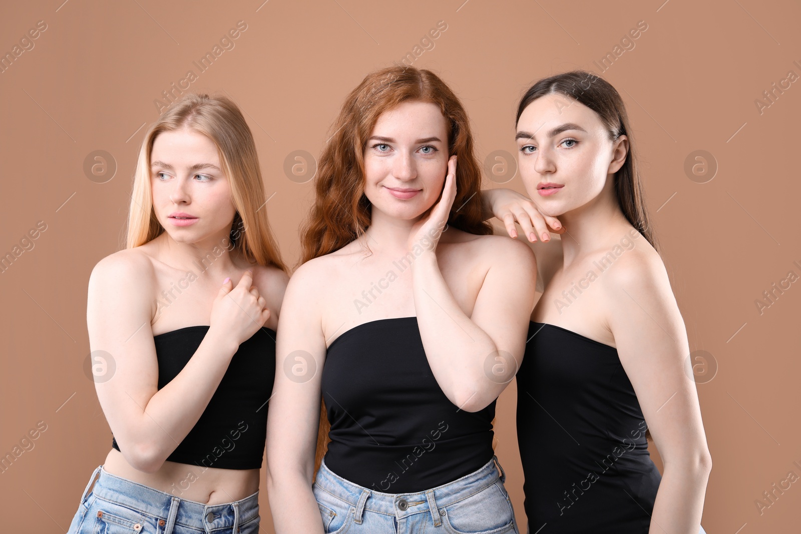 Beautiful women with different hair colors on dark beige background Photo of Beautiful women with different hair colors on dark beige background