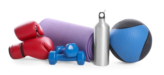 Photo of Medicine ball, dumbbells, boxing gloves, water bottle and fitness mat isolated on white