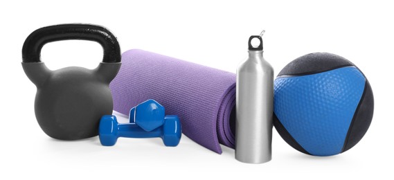 Photo of Medicine ball, dumbbells, kettlebell, water bottle and fitness mat isolated on white