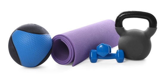 Photo of Medicine ball, dumbbells, kettlebell and fitness mat isolated on white