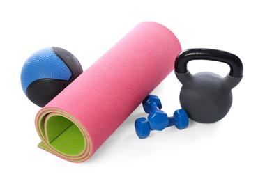 Photo of Medicine ball, dumbbells, kettlebell and fitness mat isolated on white