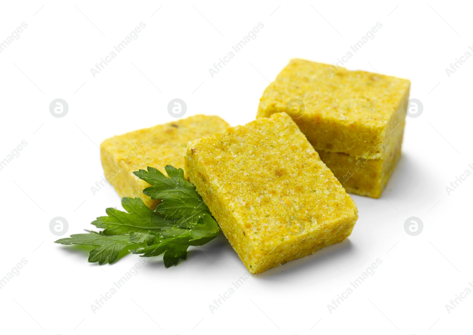Tasty aromatic bouillon cubes and parsley isolated on white Photo of Tasty aromatic bouillon cubes and parsley isolated on white