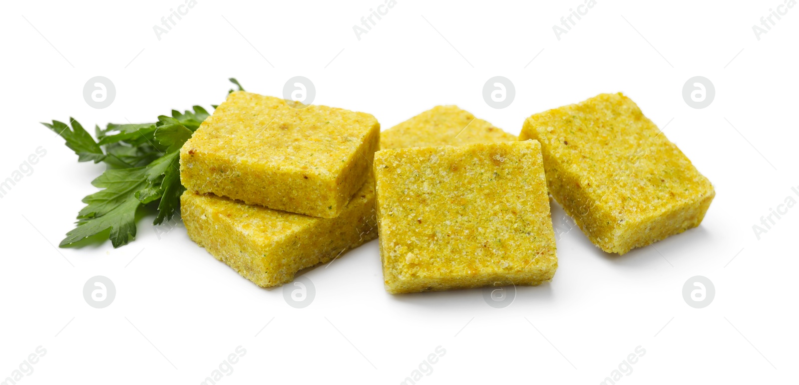 Tasty aromatic bouillon cubes and parsley isolated on white Photo of Tasty aromatic bouillon cubes and parsley isolated on white